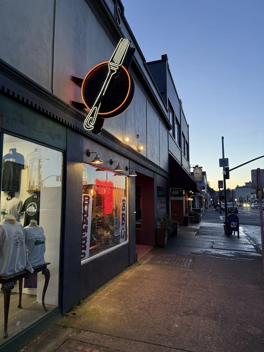 Goondocks Bistro exterior and illuminated fork sign at dusk